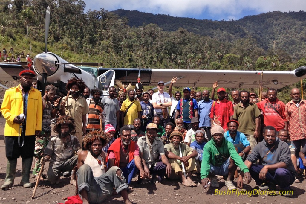 Happy looking locals posing with the first aircraft to land on their new airstrip